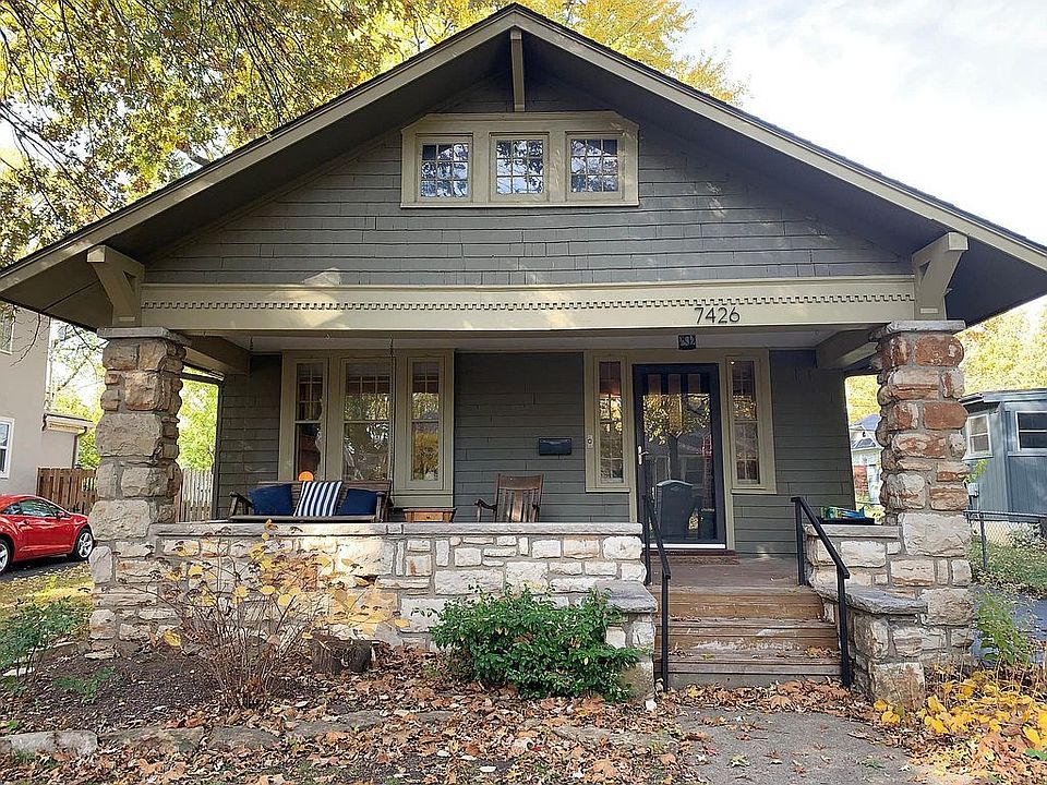 Stone-wrapped front porch with swing.