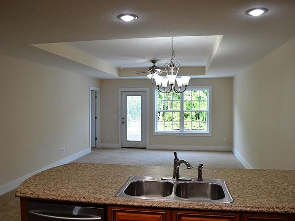 Large open living room with plenty of light and a view of the lake.