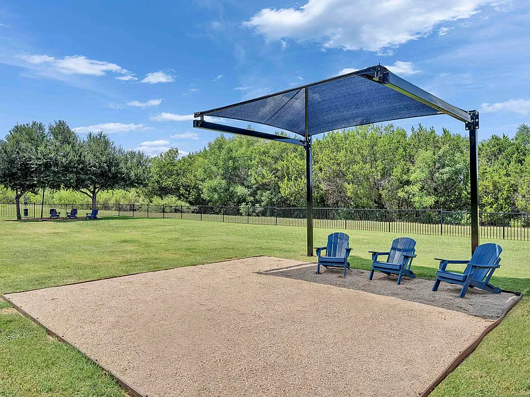 Expansive on-site dog park with covered awning