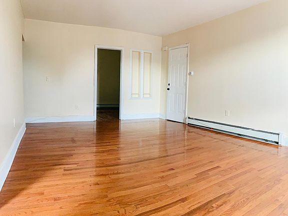 living room, view from the smaller bedroom - entrance to the right, bigger bedroom door straight ahead and kitchen to the left