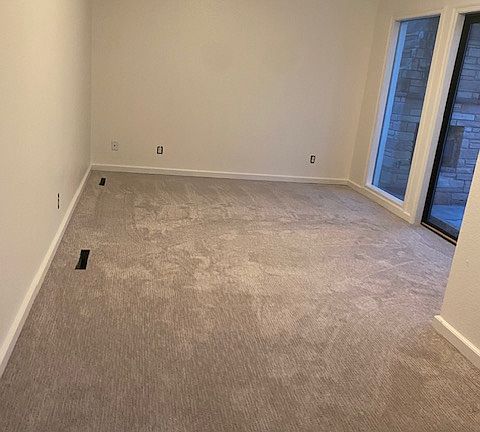 East bedroom (fresh paint and new carpet shown here).