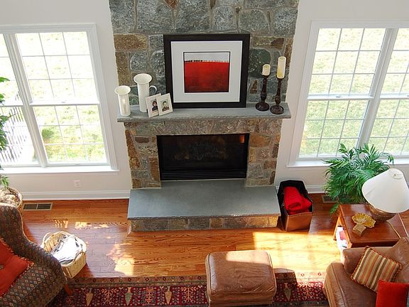 DRAMATIC TWO STORY FAMILY ROOM WITH STONE FIREPLACE.