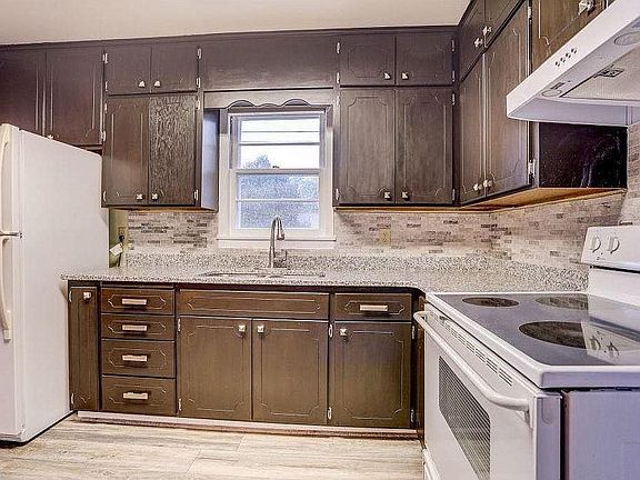 Granite counter tops, tile backsplash and refinished cabinet