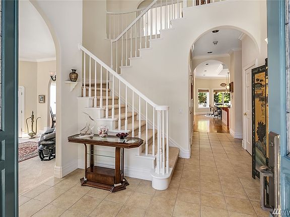 Large double door entry with twenty foot ceiling (too large to capture here), chandelier and rounded stairway are highlights.