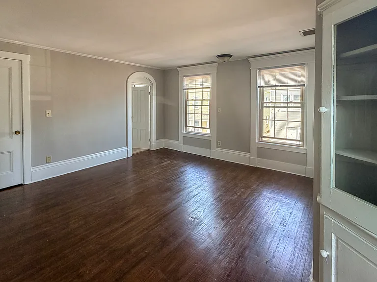 Living room with closet on the left and built in cabinet