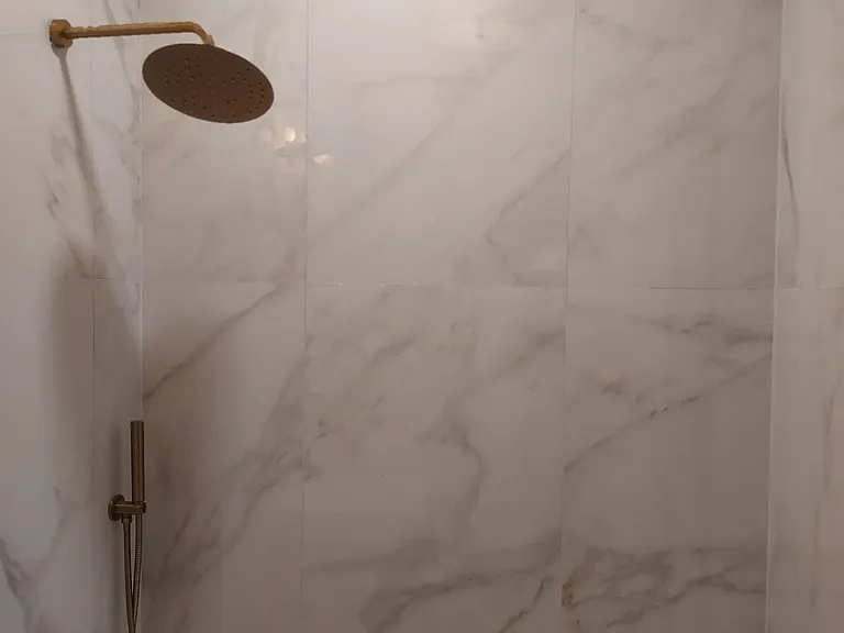 Brand new bathroom with a rare cast iron soaking tub and European finishes