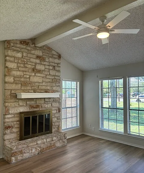 Living room fireplace and exterior windows facing out the front of Unit B.