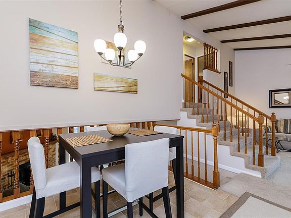 Breakfast room with ceramic tile floor open to living room and family room.