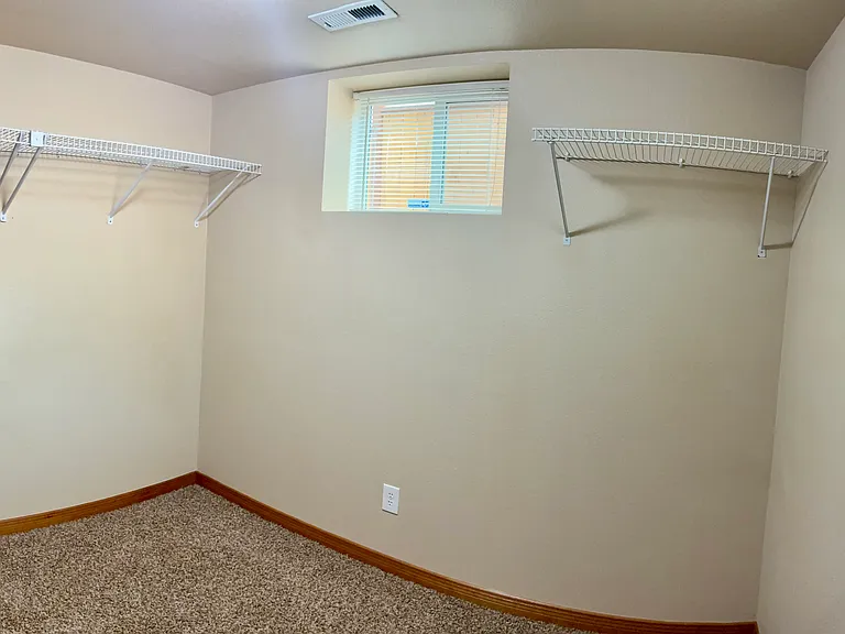 Walk-in closet with shelving space.