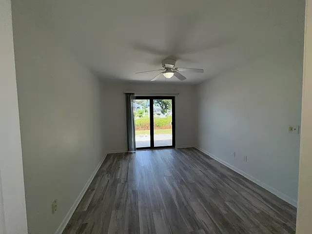 Primary Bedroom, impact patio doors to patio. New LVT Flooring.