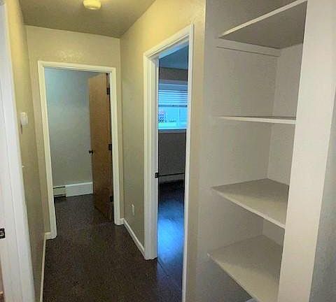 Hall storage, entry to bedroom, walk-in closet and bathroom