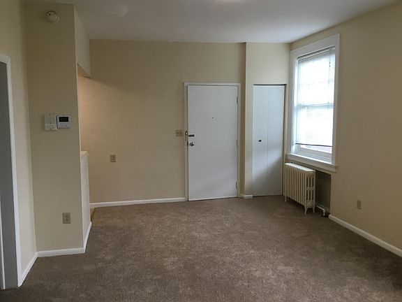 View of front door with Kitchen on the Left