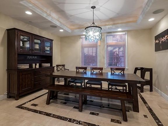 Separate Dining Room is perfect for large gatherings.  Custom tile floor design, upgraded lighting and tray ceiling with crown molding add to the elegance of this dining room.