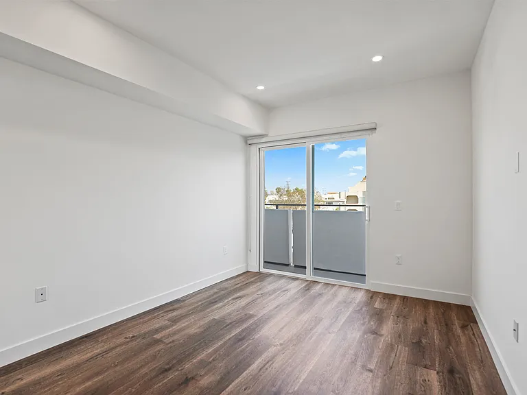 Bedroom with Recessed Lighting, Vinyl Flooring, and Balcony