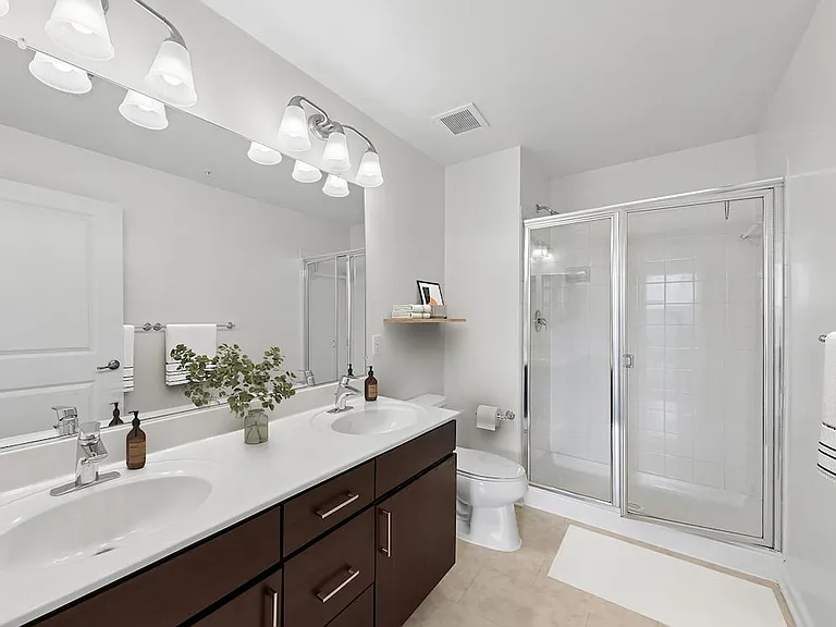 Updated Finishes bath with laminate countertop, espresso cabinetry, and tile flooring