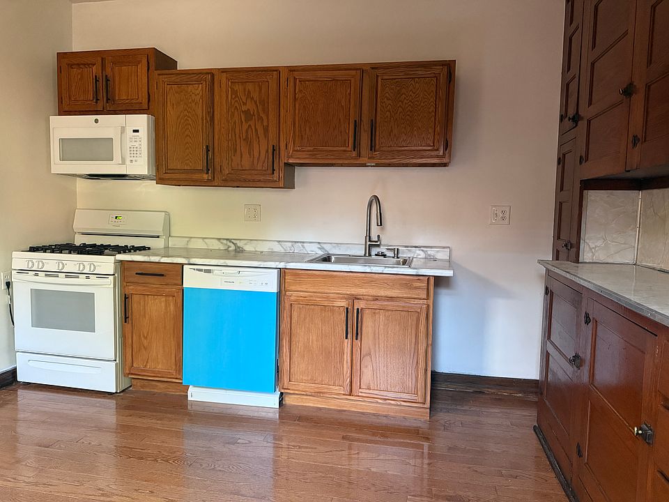 kitchen with new dishwasher and large refrigerator