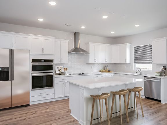 Bright white Kitchen with an island.