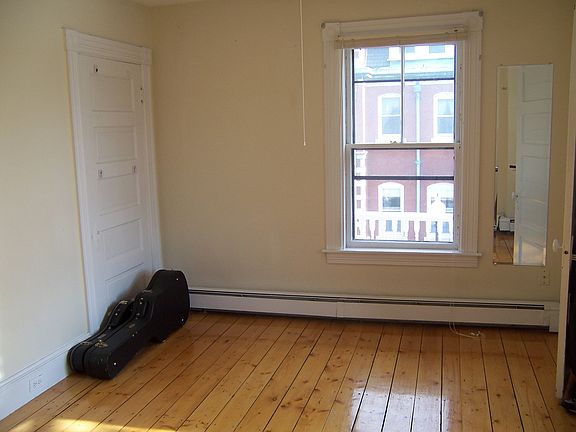 Bedroom with wood floors. Wall color is now light grey