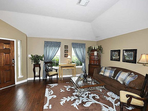 Greet your guests in the formal living room featuring gorgeous wood flooring that extends throughout
