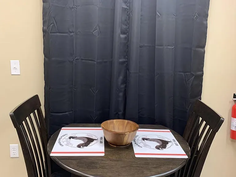 Compact dining nook with a two-person table setup, ideal for everyday meals or a quick workspace.
