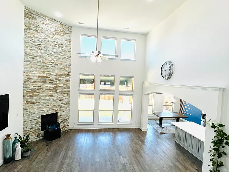 Living area with high ceilings and large windows