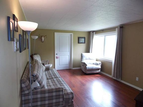 Comfortable sized living room glistens with natural light flowing in through the newer windows.