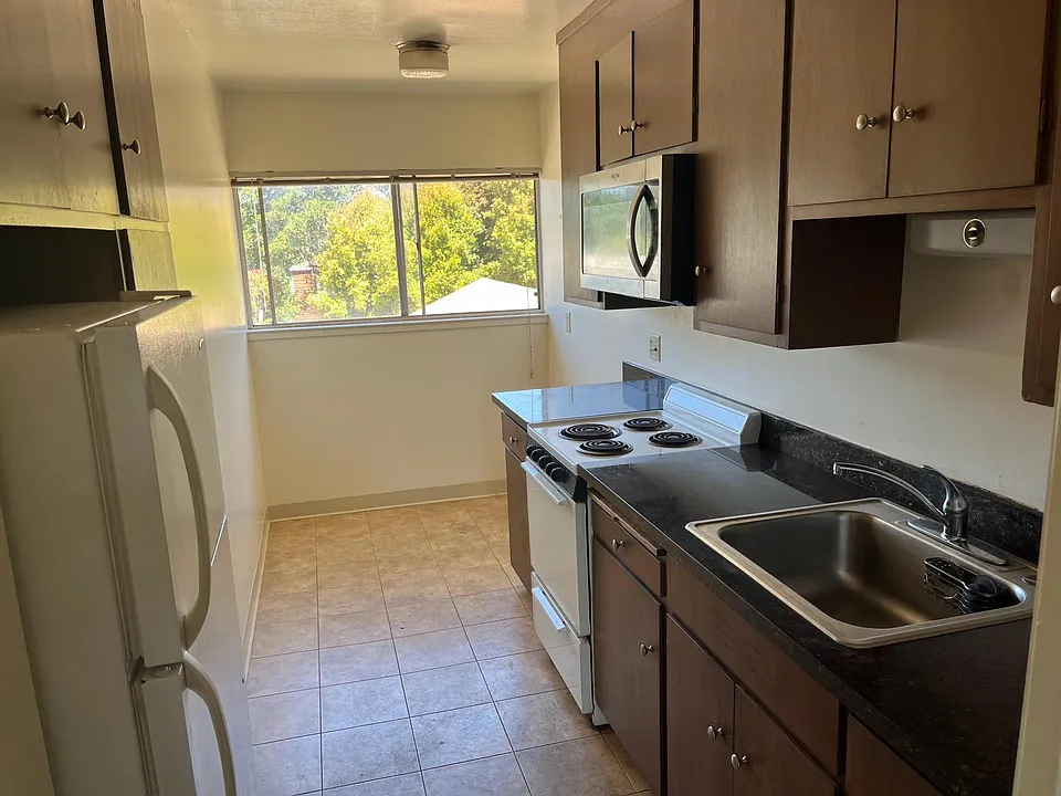 Kitchen with stove, fridge and microwave
