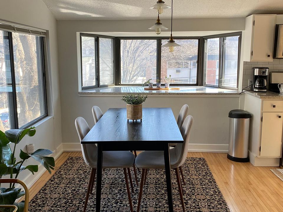 Dining room with bay window with granite shelf for plants.