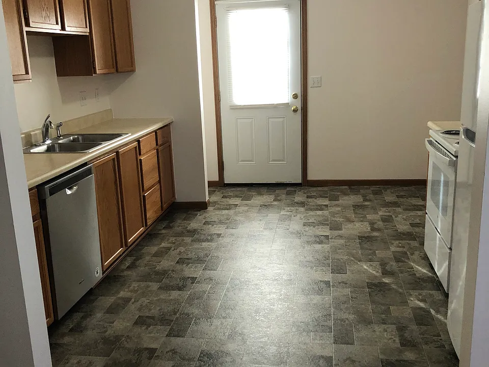 Kitchen with new flooring, appliances, area to add stackable washer/dryer, and small eat-in area.