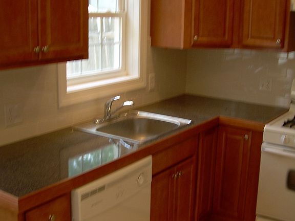 Eat in kitchen with maple cabinets and subway tile backsplash