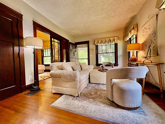 Living Room, the coat and storage closet, an open French door, and a front door leading to the front porch