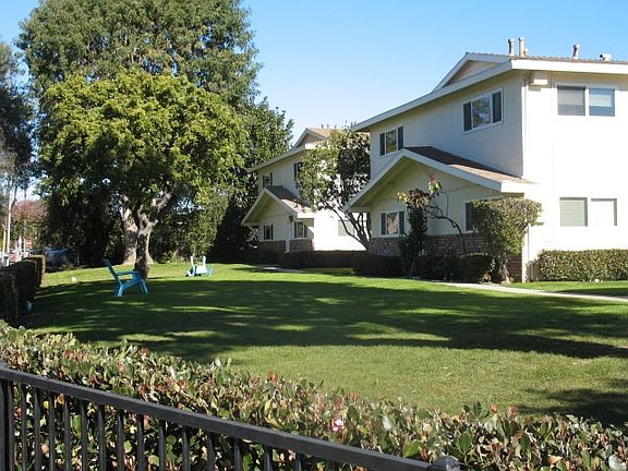 Photo showing all of the trees & grass around the buildings