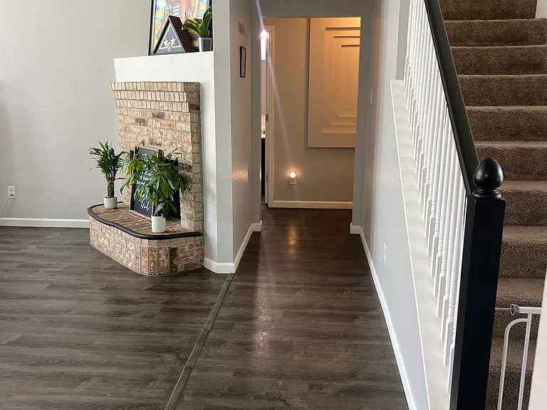 Hall Way leading to Primary Suite, Half-bath, and Garage