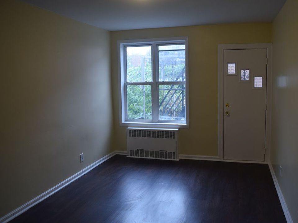 Bedroom w/ laminate wood floors & back door