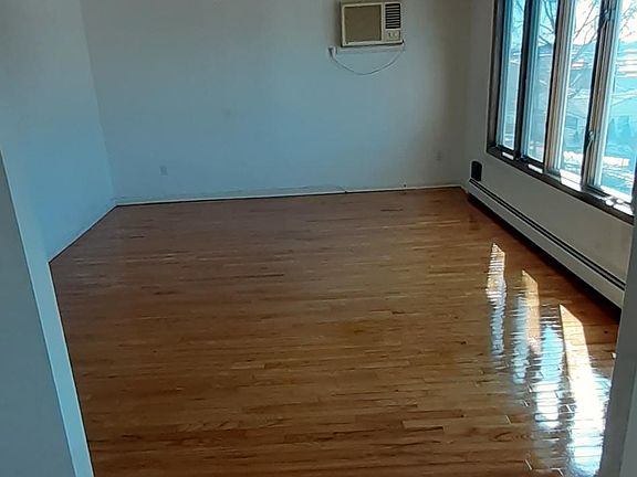 Spacious open-layout living room... Newly finished hardwood floors.