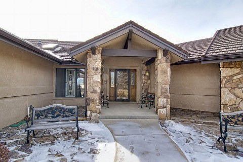Covered Front Porch Accented by Natural Stone