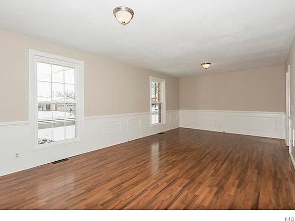 Large living room with laminate flooring. This room is large enough to serve as a living room and di
