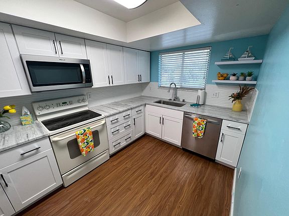 Granite countertops with new dishwasher, new microwave and white cabinets