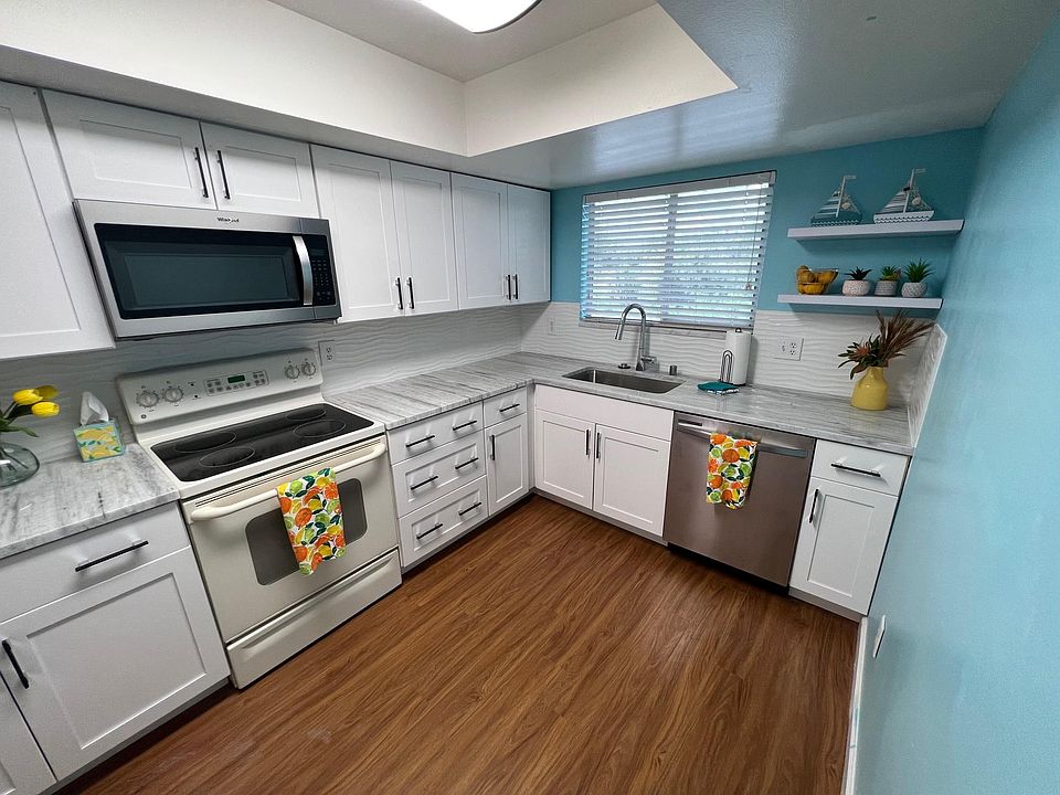 Granite countertops with new dishwasher, new microwave and white cabinets