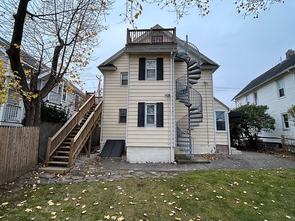 Back of building - Side Wooden Staircase to second floor private entrance - Spiral Staircase to third floor private entrance