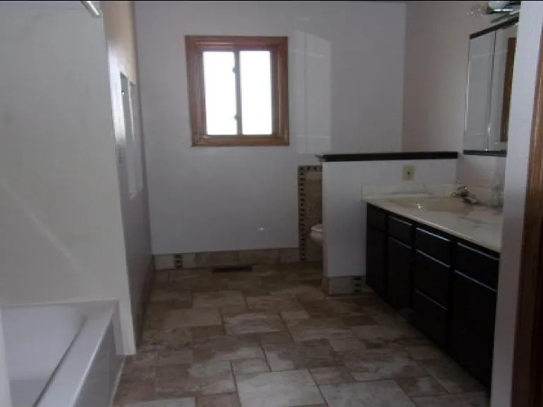 FULL SIZE BATHROOM WITH BEAUTIFUL TILE WORK; HUGE MIRRORS; 2 SINKS; SHOWER/BATH COMBINATION; LARGE CLOSET SPACE AND CABINETS