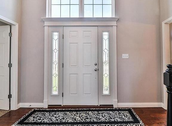 A view from mid Entry toward the front of the residence.  The door to the Left is the Double Door System leading to the Master Suite.  Notice that the Classic trim work of the exterior has been repeated on the interior Entry Door.