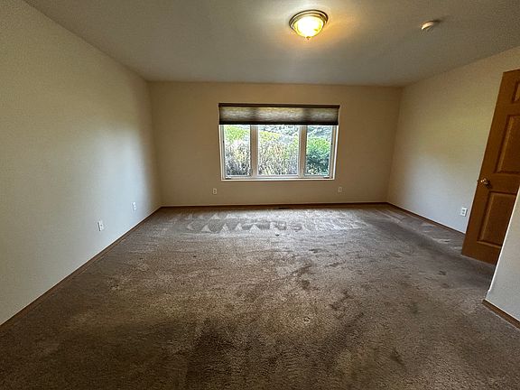 Carpeted master bedroom.
