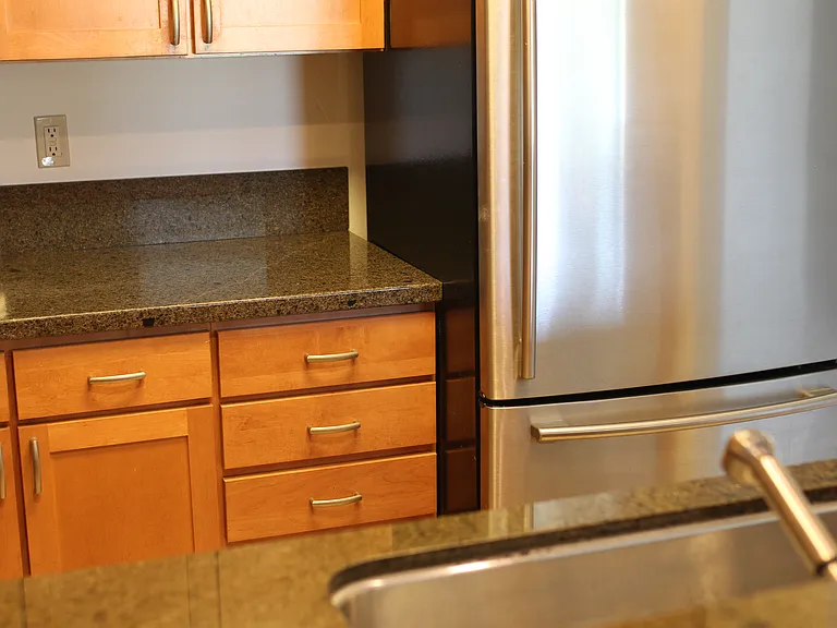 Kitchen with granite counter tops, stainless steel appliances.