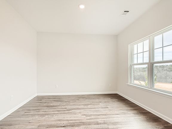 Formal dining room, located near the entry, with a large window.