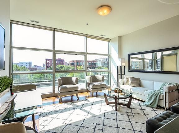 Living Room with Wall of Floor to Ceiling Windows that opens