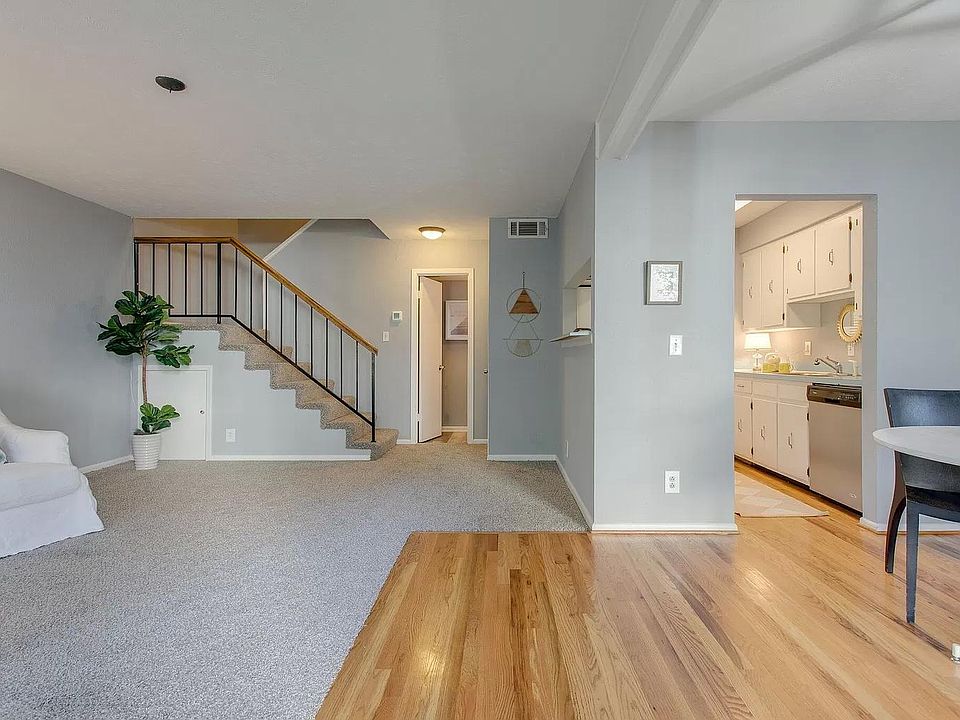 Living Room, Dining Room, and Kitchen with View to stairs to 2nd floor