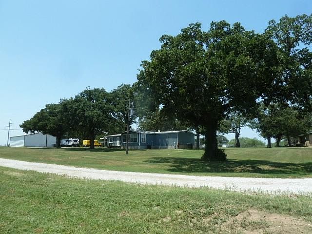 1978 DOUBLE WIDE WITH 30X40 SHOP, INGROUND SWIMMING POOL, RV HOOK UP WITH ELECTRIC AND SEWER, 4.35+- ACS. WITH SECOND BRICK HOUSE BUILT IN 21007 WITH 4-2 4 CAR CARPORT, ALL FENCED AND CROSS FENCED.