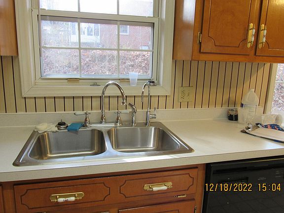 Stainless steel sink is easy to keep clean. Mounted on the top are 2 new faucets - one for doing dishes and another for dispensing purified water for drinking, cooking, and washing foods.