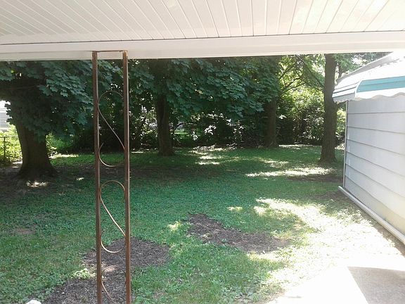 Looking out in backyard from covered patio